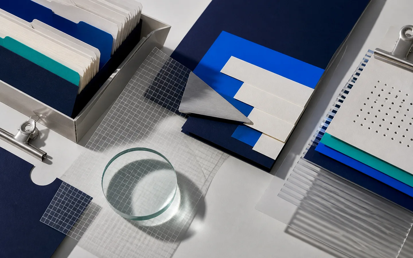 Index cards, translucent grid film and research materials arranged for a search study.